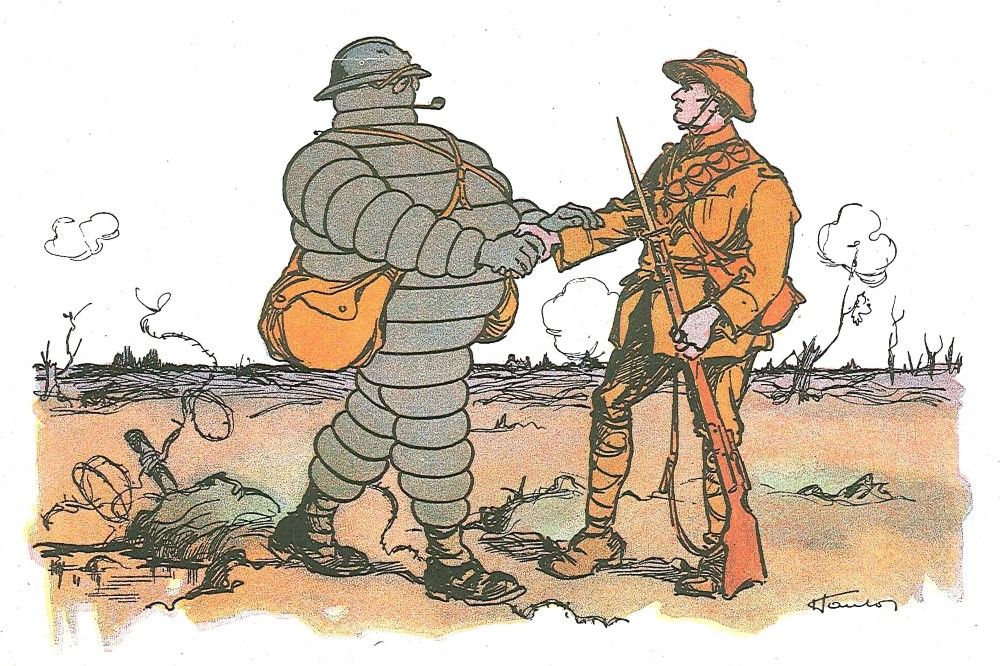 The illustration shows Bibendum, in combat uniform, shaking hands with a soldier on a battlefield.
