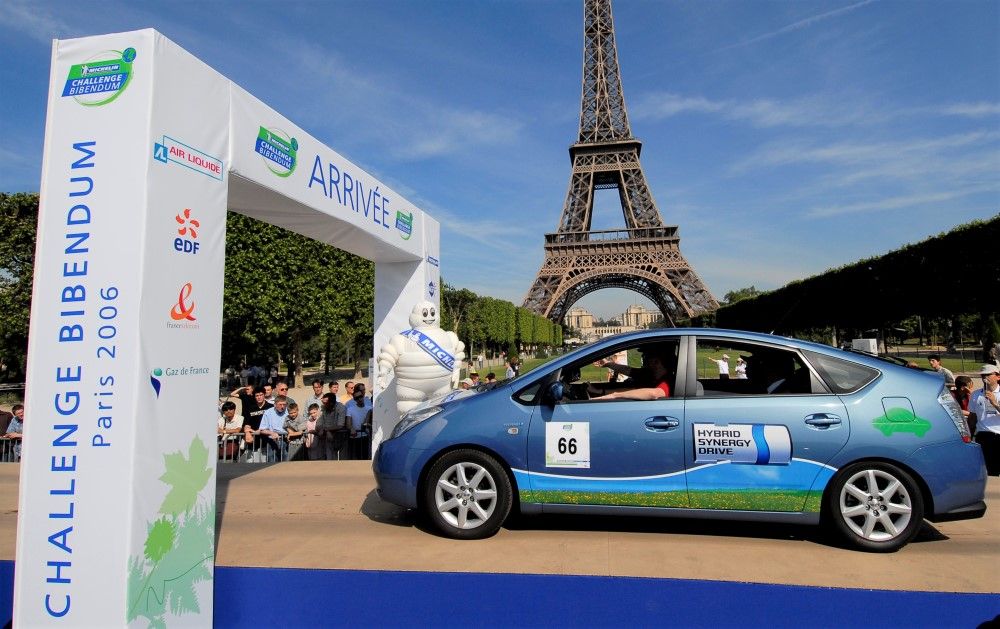 Photograph of a car at the finish of the Challenge Bibendum in Paris. The Eiffel Tower is in the background.