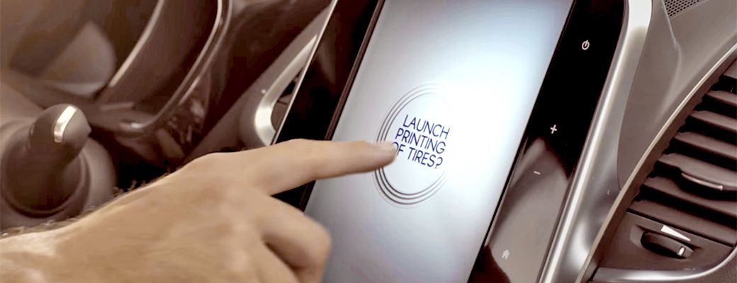 Image of an index finger pressing the 'Launch printing of tires?' command.