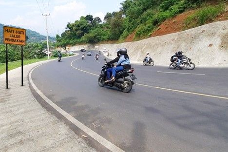 A group of people on motorcycles on a road