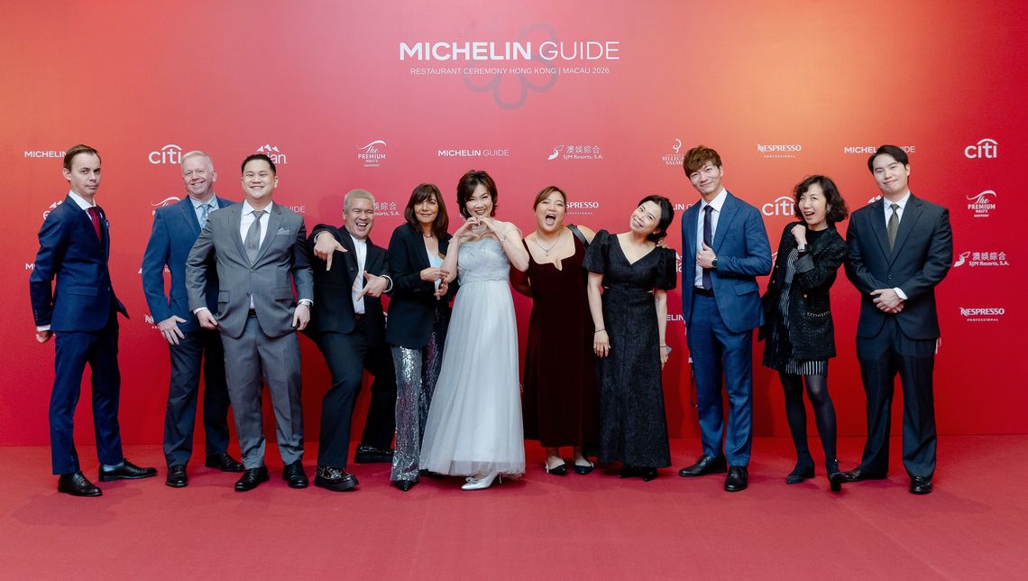 A diverse group of Michelin team members posing together on the red carpet at a MICHELIN Guide Asia Pacific event, representing inclusion and collaboration.