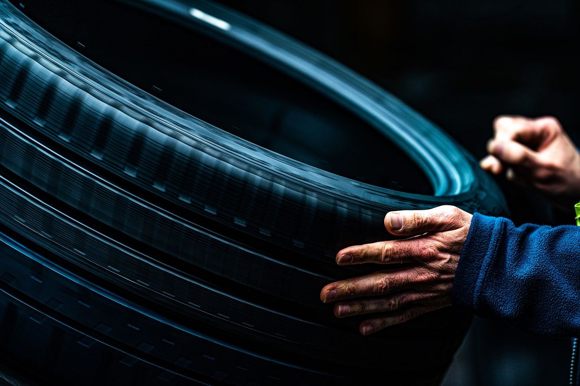 Michelin employee checks tire quality by touch and sight