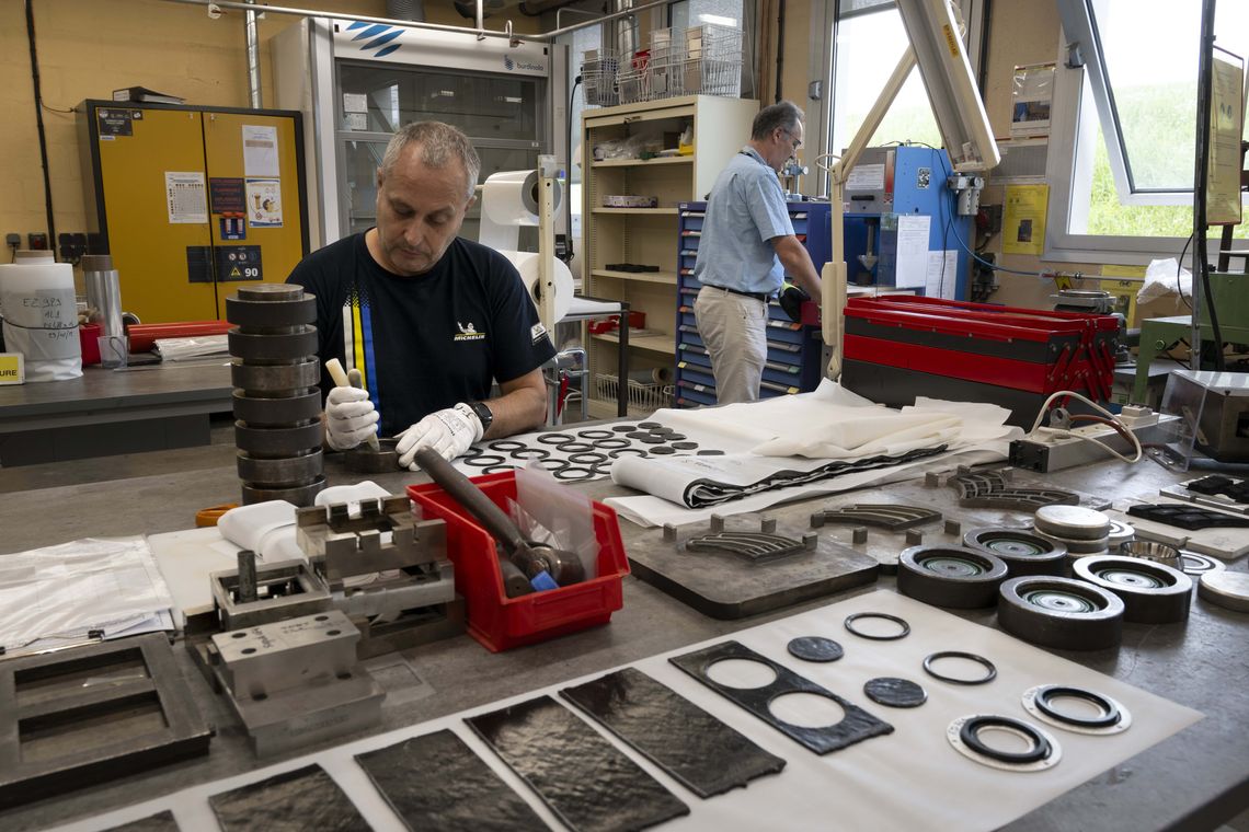 A man prepares parts of different calibers for testing in a workshop.